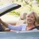 Woman in convertible car smiling